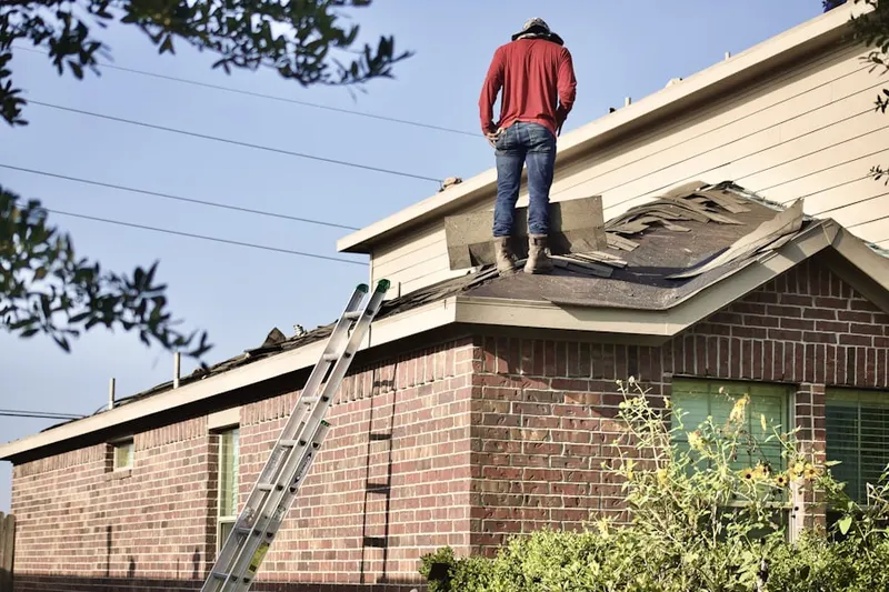 Professional roofer working on a residential roof in Century Cove